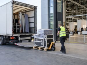 Exhibition equipment being unloaded from a truck at a European trade fair venue